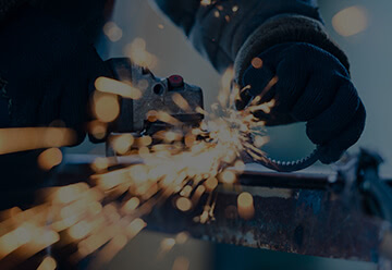 Close up of sparks from a technician cutting an forming metal