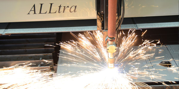 Sparks and flames coming from the ALLtra 400 Plasma and Flame Cutting machine at Millwood Metalworks in Freeport, MN